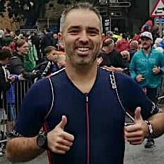 Mark on run in IronMan Wales being cheered on by crowds.